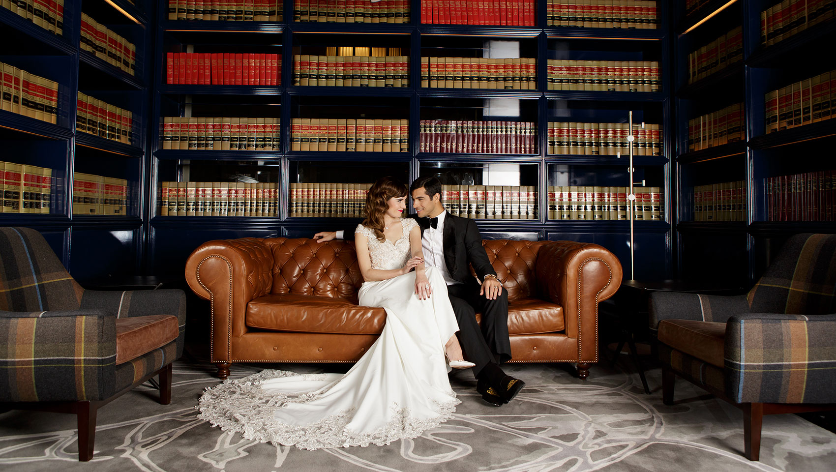 Wedding couple on leather couch at Kimpton Gray Hotel