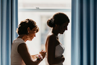 bride getting ready with mother