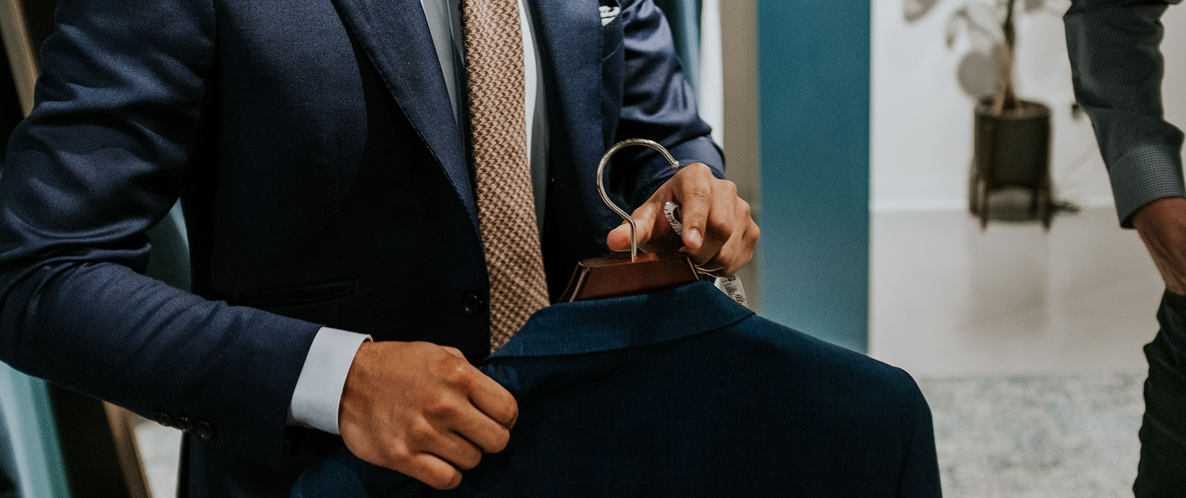 Business man holding suit jacket on a hanger